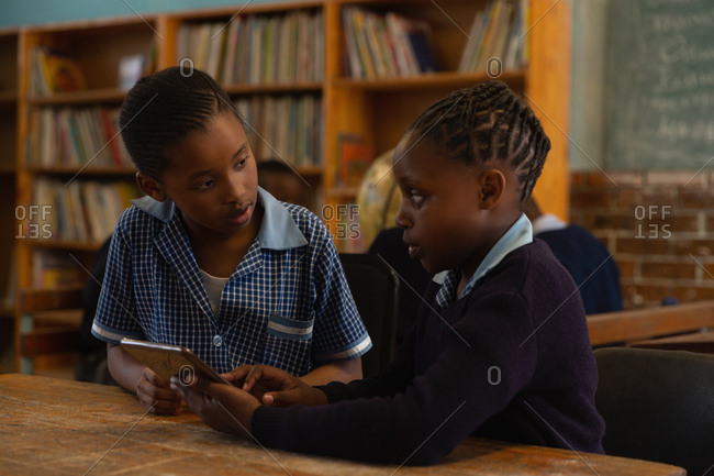 School kids using digital tablet in classroom at school