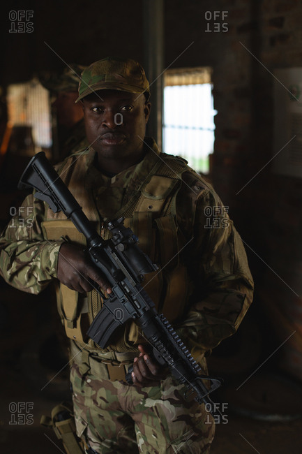 Military soldier standing with rifle during military training in military camp