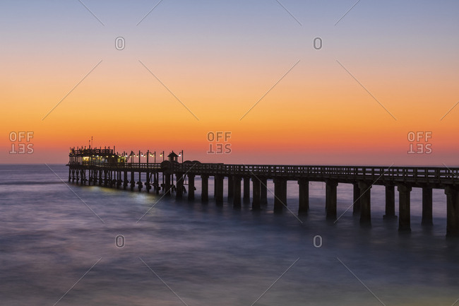 Namibia, Namibia, Swakopmund, View of jetty and Atlantic ocean at sunset