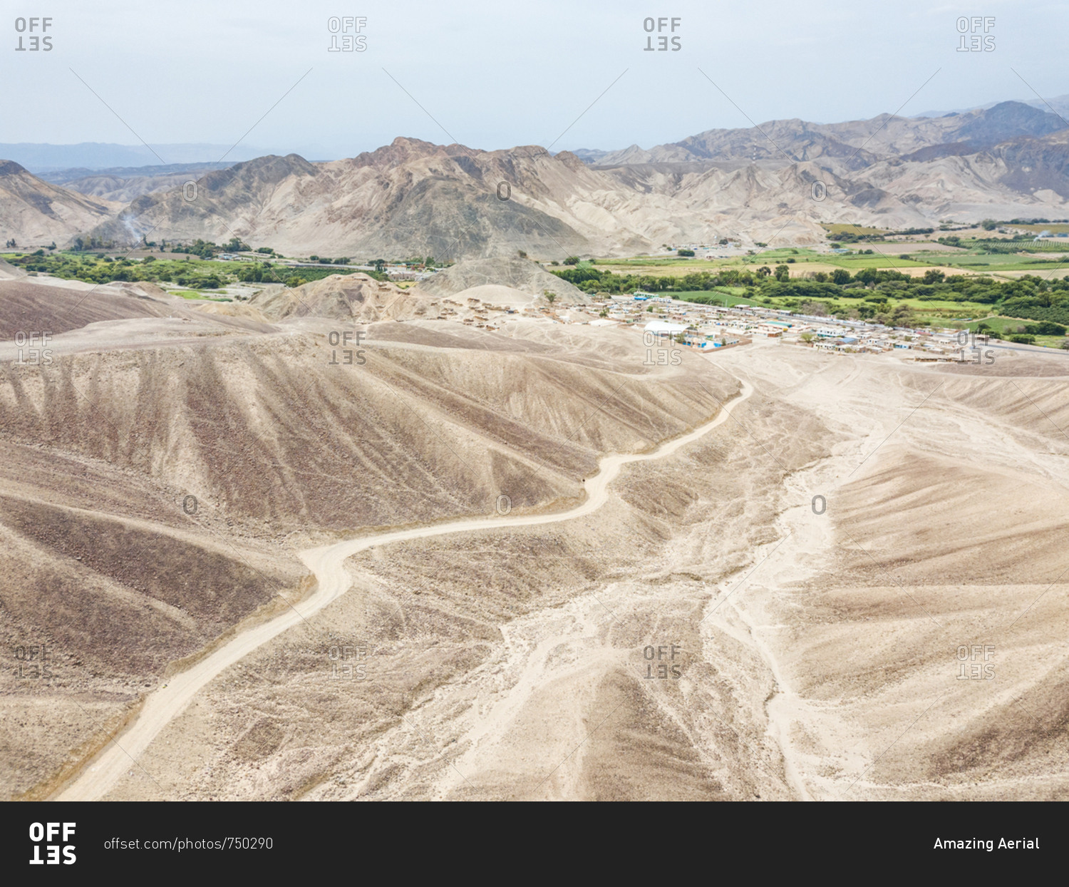 Aerial view of Nazca desert, town and mountains, Peru