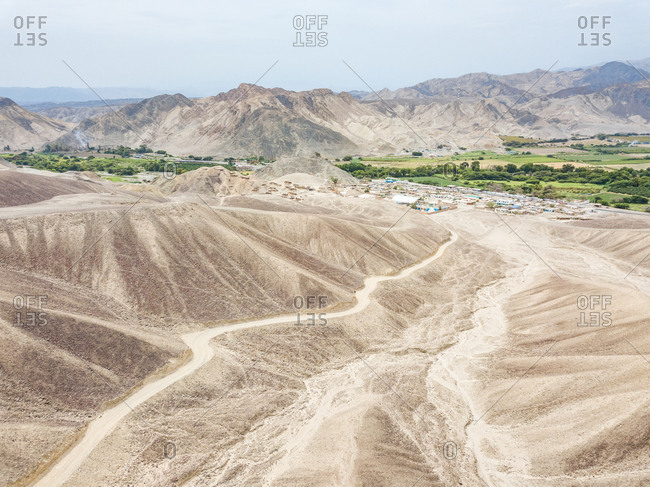 Aerial view of Nazca desert, town and mountains, Peru