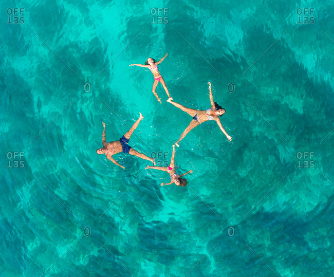Aerial view of family of 4 playing in Adriatic sea, Sutivan, Croatia