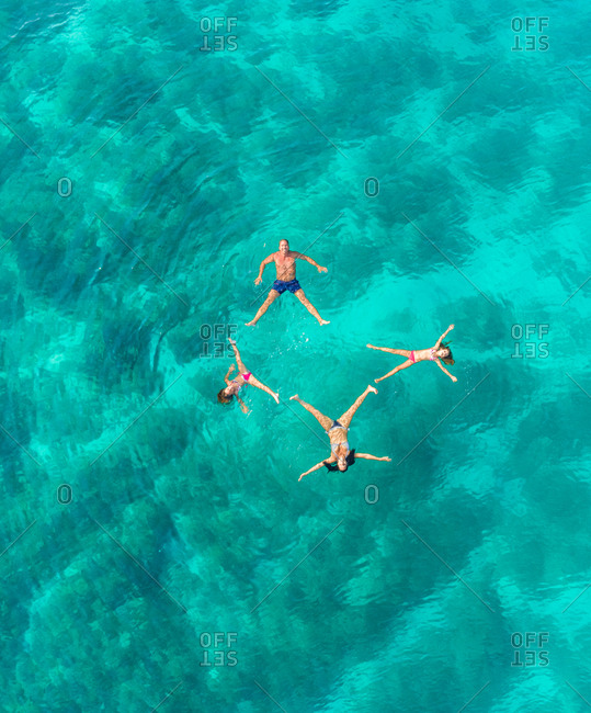 Aerial view of family of 4 playing in Adriatic sea, Sutivan, Croatia