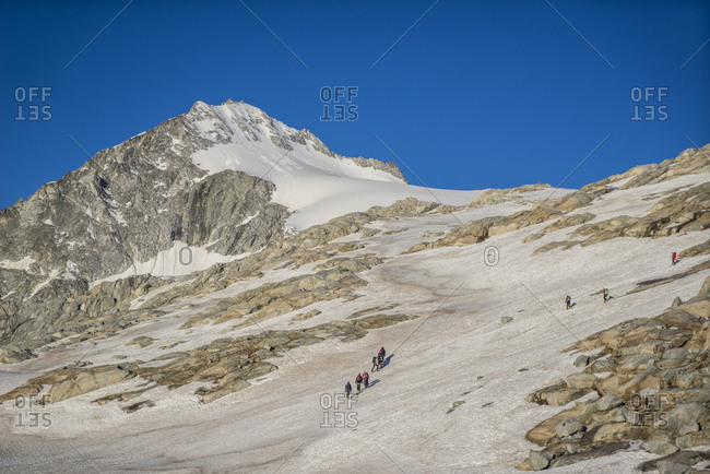 Italy, Trentino Alto Adige, Valdaone, hikers crossing i Pozzoni,  the starting place to cross Vedretta di Lares Glacier, in the Adamello Mountain Group