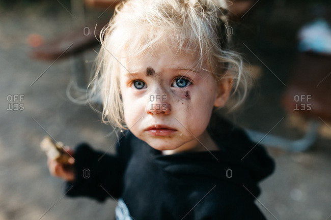 Portrait of a little girl with a dirty face