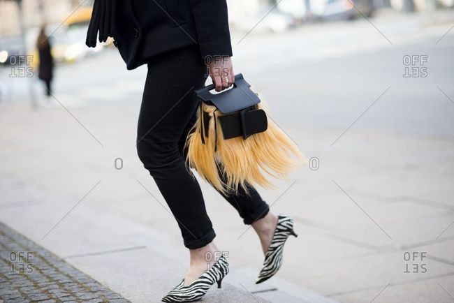 Copenhagen, Denmark - September 21, 2018: Woman wearing animal print shoes and carrying furry bag