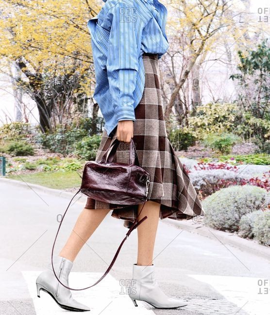Paris, France - September 21, 2018: Woman wearing silver boots and brown skirt