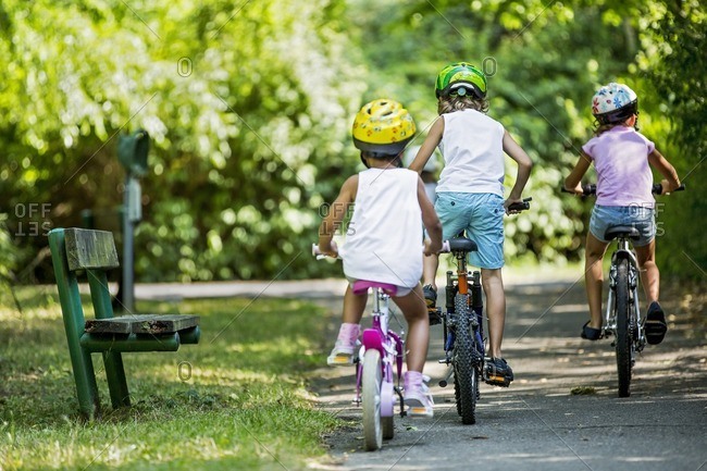 Children cycling in park
