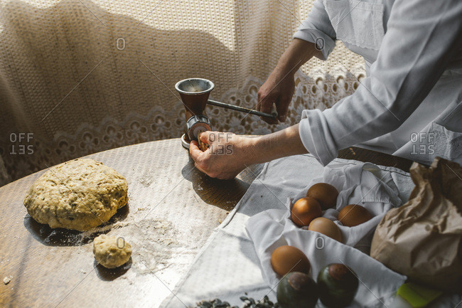 Woman Preparing Homemade Dough in the Kitchen and using a mincing machine. Preparation Raw Dough for Baking