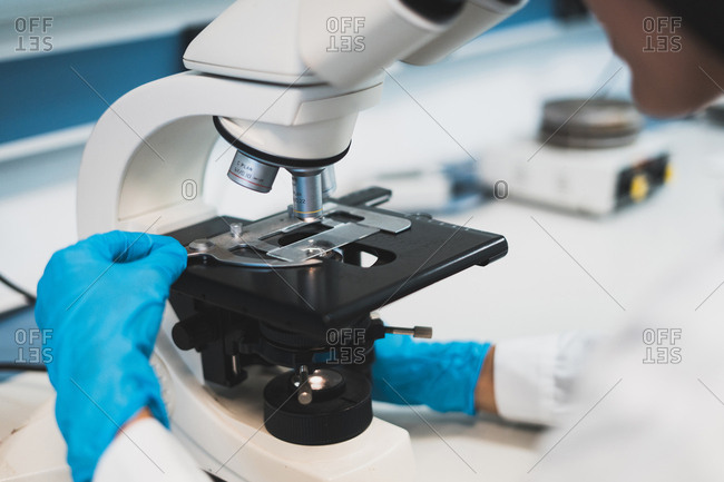 Person working with microscope in lab