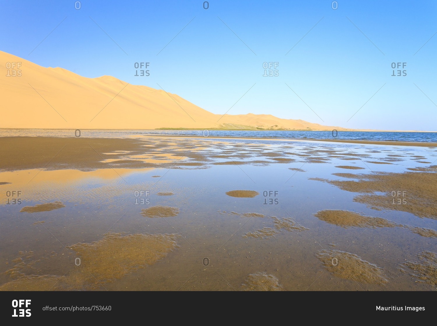 Sand dunes reflected in the lagoon beside the Atlantic Ocean Walvis Bay Namib Desert Erongo Region Namibia Southern Africa