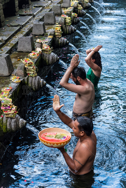 July 5, 2018: Bali, Indonesia July, 5, 2018: People bathing in the waters of the Tirta Empul Water Temple, Ubud, Bali