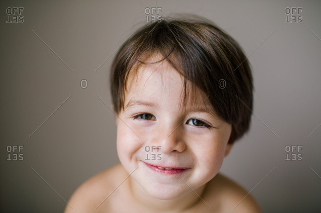 Portrait of a smiling boy with brown hair and brown eyes