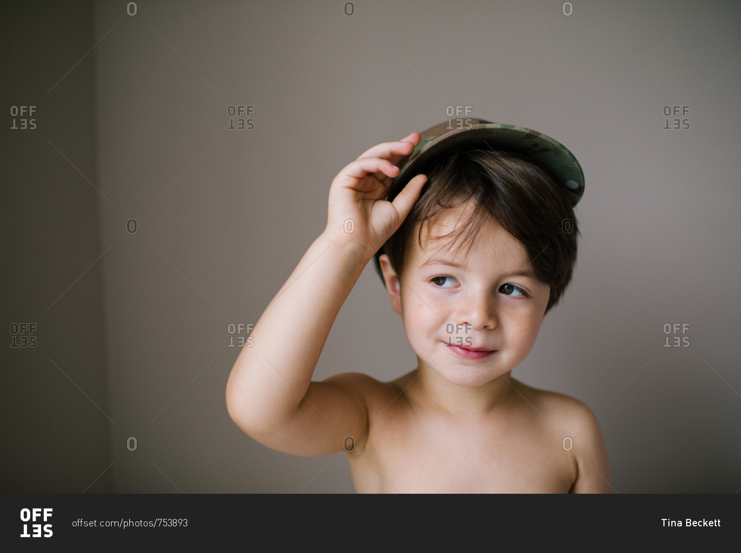Portrait of a boy tipping hat and looking to side stock photo OFFSET