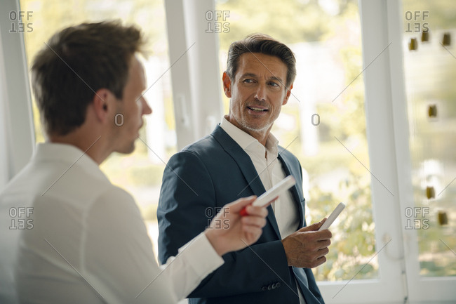 Mature businessman sharing his knowledge with younger colleague