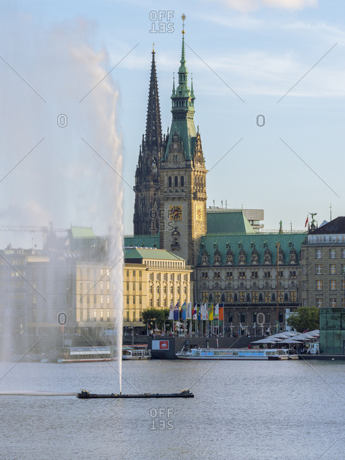 August 27, 2017: Germany- Hamburg- city hall and St Nikolai Memorial with Inner Alster and Alster fountain in the foreground