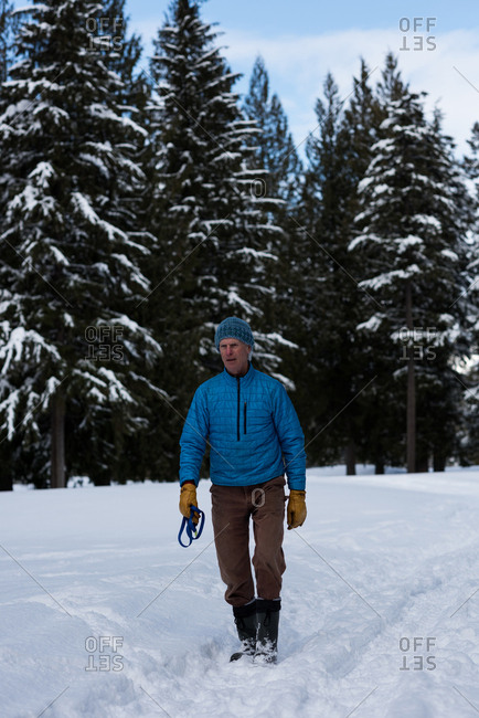 Man with dog collar standing in snowy landscape during winter