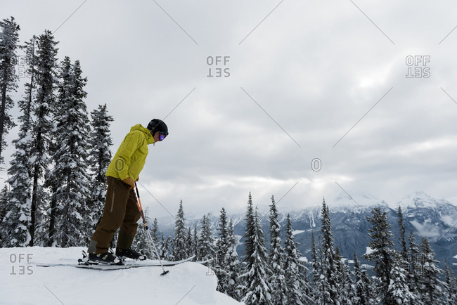 Skier skiing on snowy landscape during winter