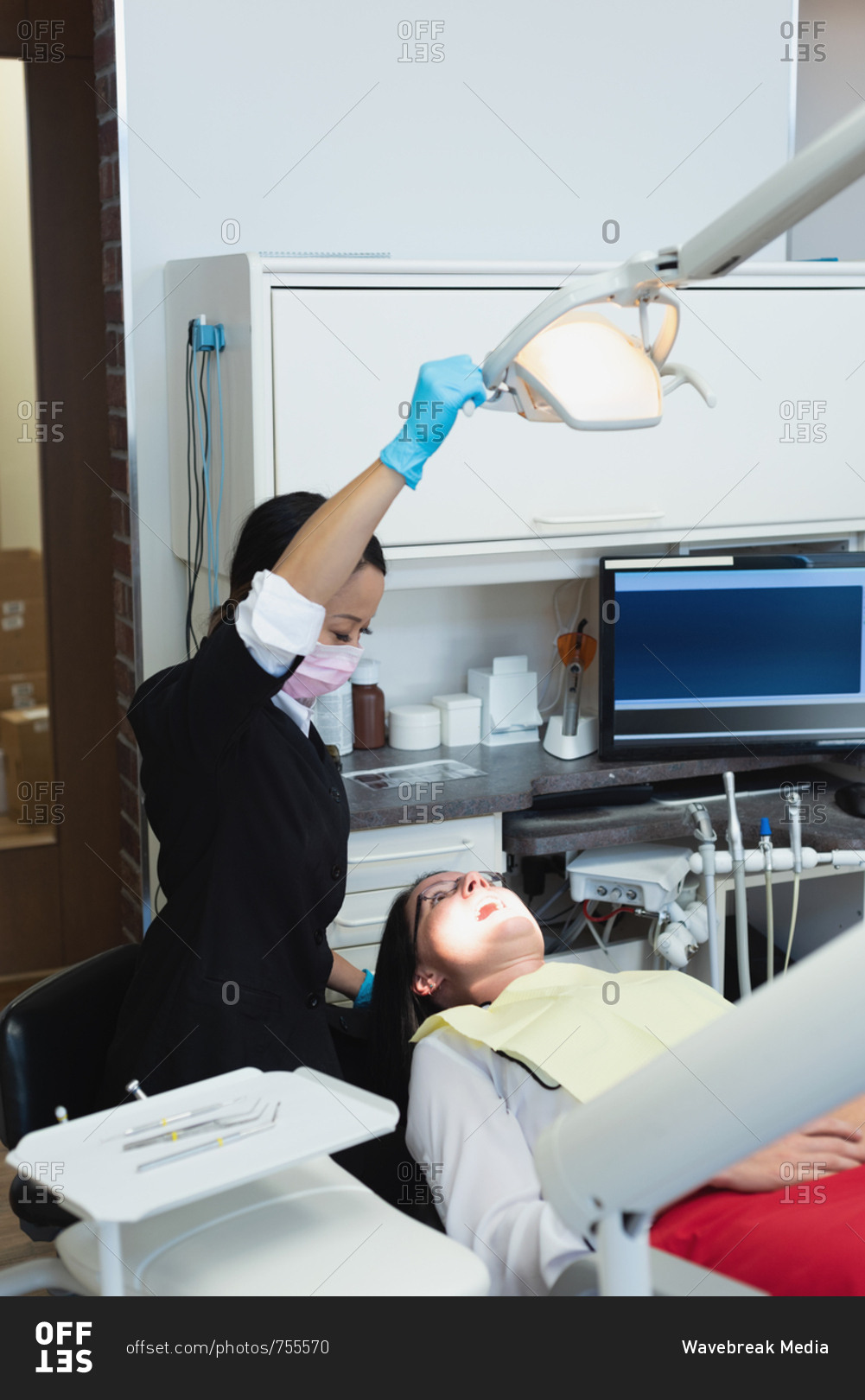 Female dentist examining a patient in dental clinic