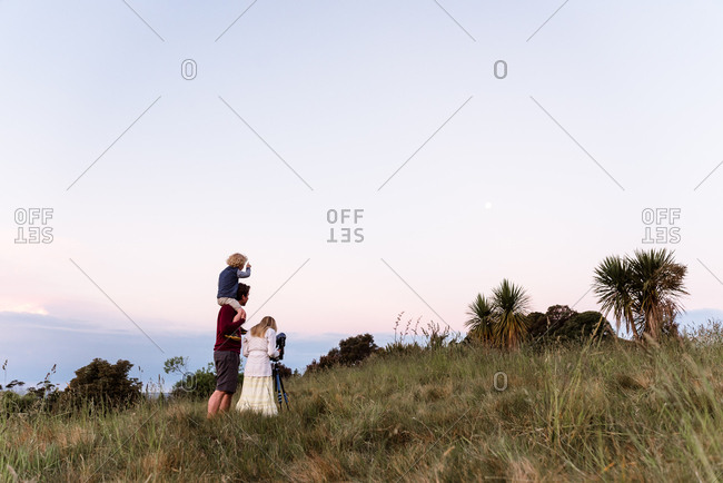 Family looking through a telescope