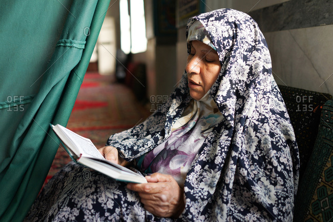 Muslim woman is praying and reading the  quran