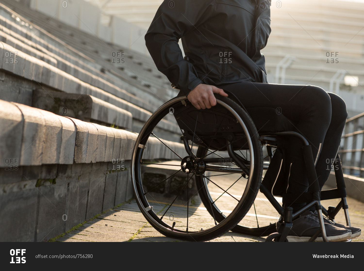 Low section of disabled athletic moving with wheelchair at sports venue