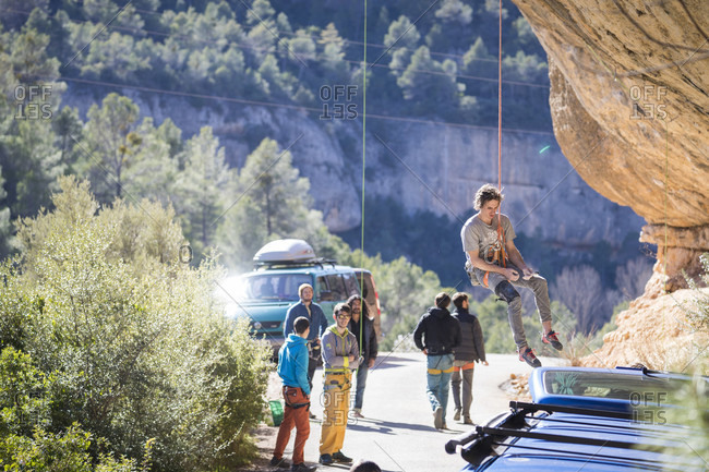 March 7, 2018: Male climber getting lowered from popular climbing crag, Margalef, Catalonia, Spain
