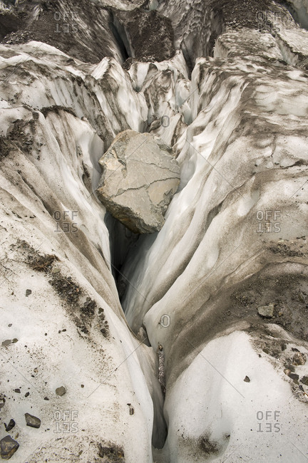Big boulder sticks in a glacier column of the fox glacier on New Zealand.