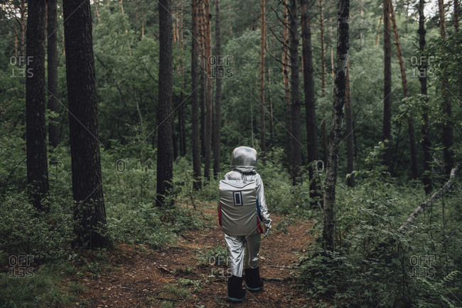 Spaceman exploring nature- walking in forest