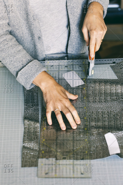 Close-up of fashion designer working on template