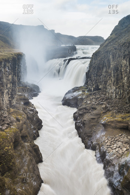 Scenic view of Gulfossi waterfalls flowing through surrounding canyon, Iceland