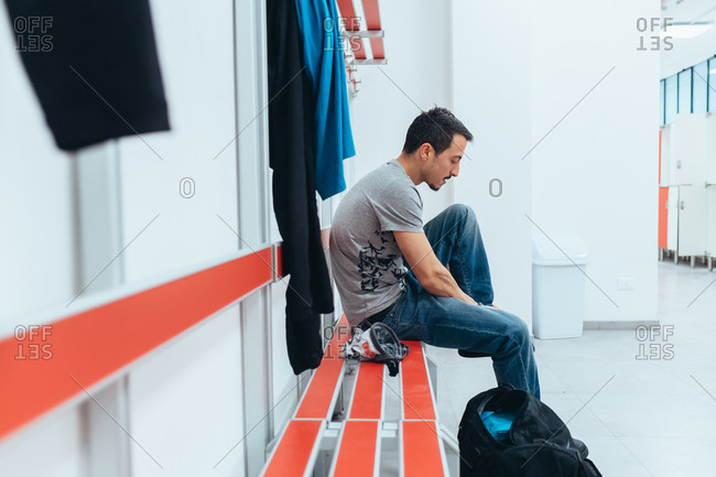 Young man preparing himself in the locker room - preparation, concentration, sportive concept