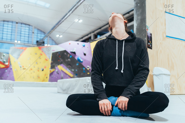 Young woman stretching indoor climbing gym - sport, athletic, fitness concept