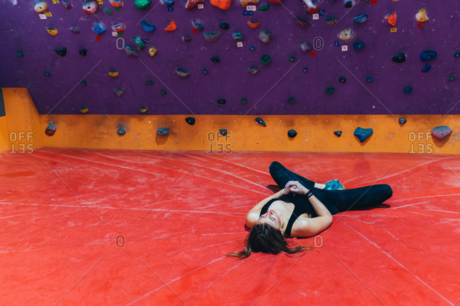 Two young adult climbing rock wall indoor - healthy lifestyle, sport, climbing concept