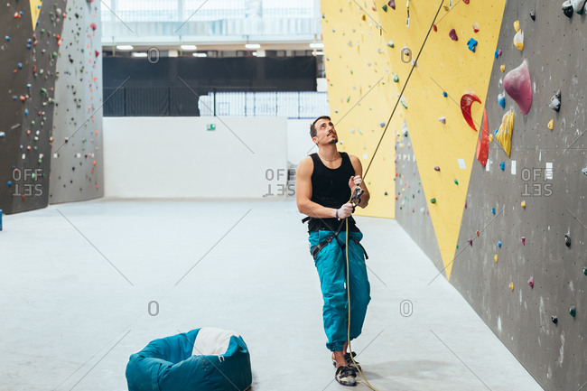 Three people climbing rock wall indoor - healthy lifestyle, sport, climbing concept