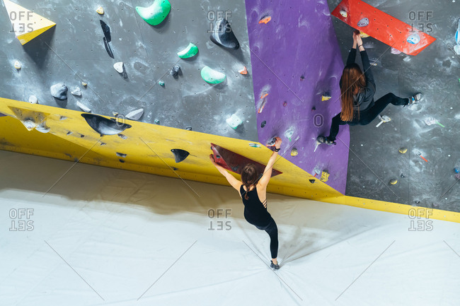 Young man preparing himself in a climbing gym - preparation, concentration, sportive concept