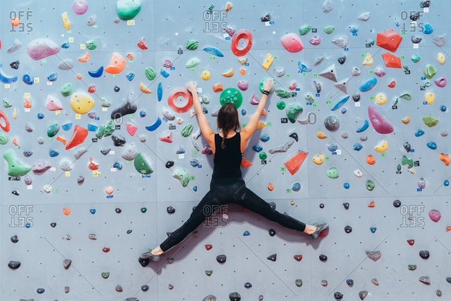 Young man preparing himself in a climbing gym - preparation, concentration, sportive concept