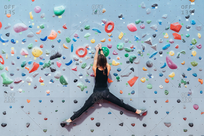 Young adult man and woman preparing with rope for climbing wall - exercise, preparation, sport concept