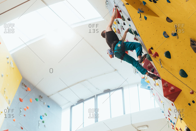 Young woman preparing himself in a climbing gym - preparation, concentration, sportive concept