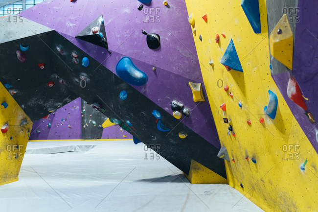 Young adult man and woman preparing with rope for climbing wall - exercise, preparation, sport concept