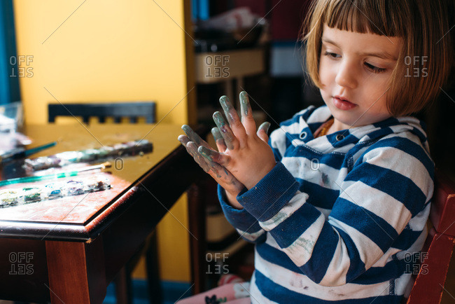 Toddler painting and getting messy