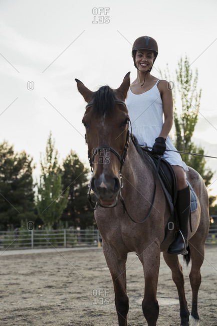 Smiling woman siiting on horse
