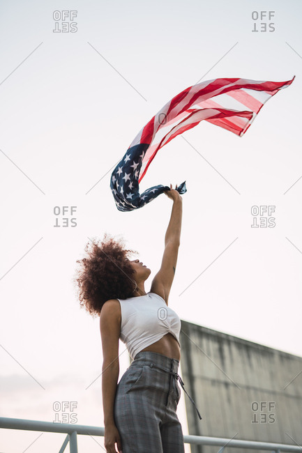 Young woman swinging American flag