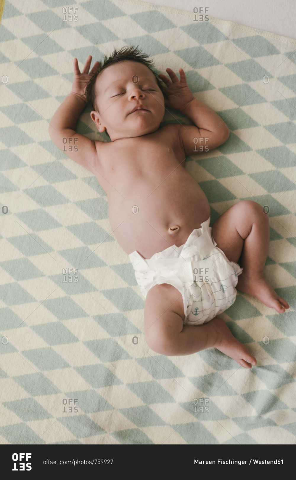 Newborn baby boy sleeping on a blanket stock photo - OFFSET