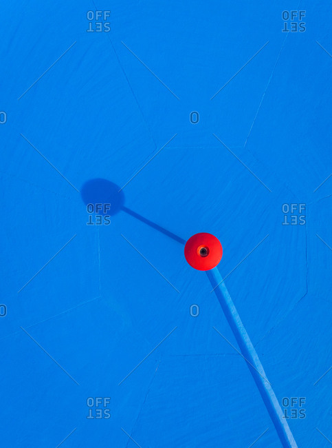 Abstract aerial view of empty pool with red fountain in abandoned water park.