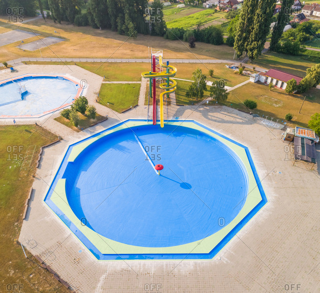 Aerial view of slide and pool in abandoned water park.