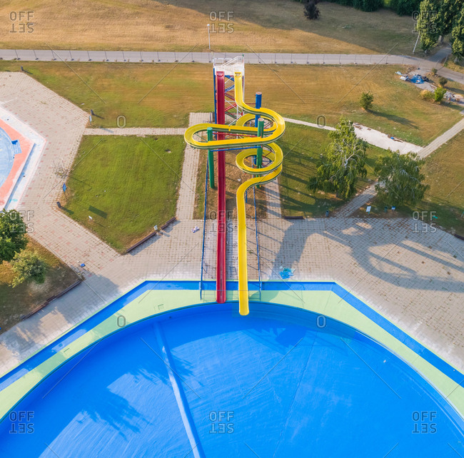 Aerial view of slide and pool in abandoned water park.