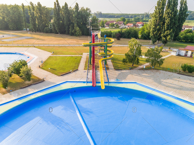 Aerial view of slide and pool in abandoned water park.