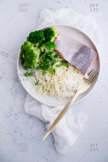 Cooked salmon with basmati rice, broccoli and beans on concrete background. Healhy nutrition concept