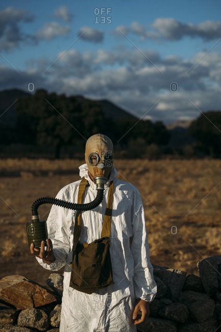Man with tear gas mask and white scientist costume